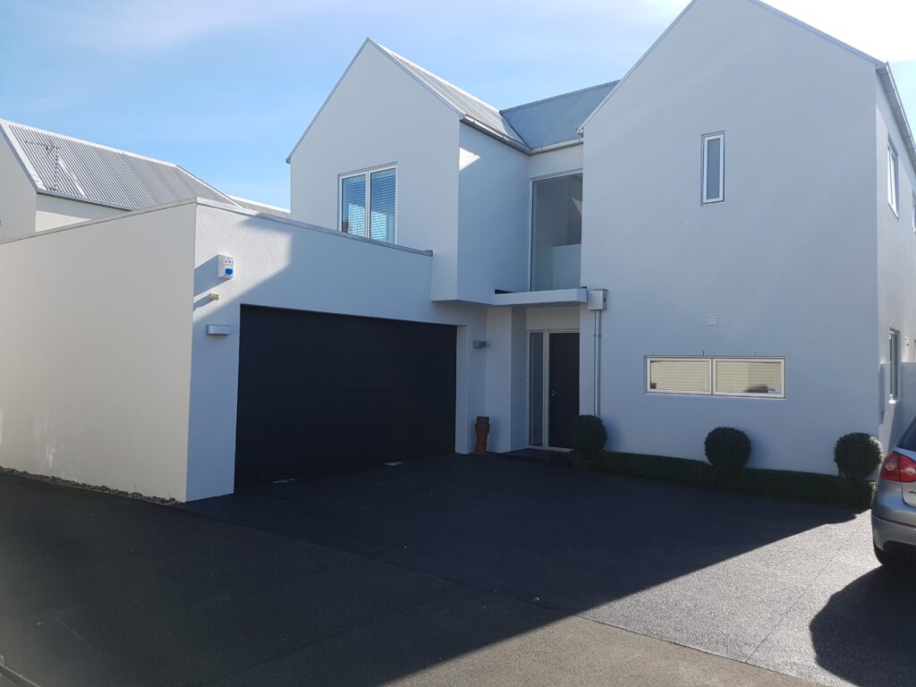 Recently painted exterior of residential property in white Papanui